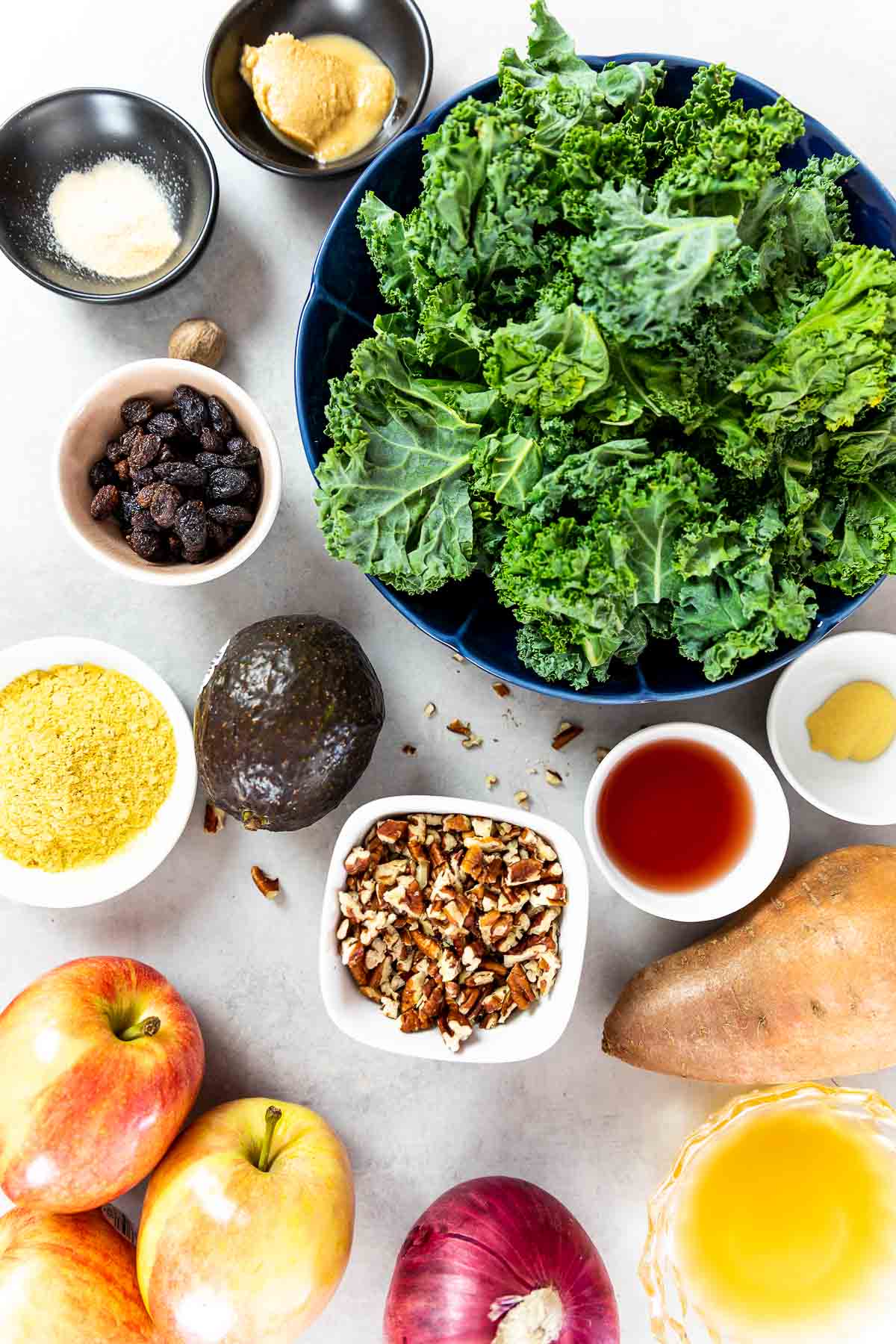 Ingredients shot of vegan kale salad with apples, sweet potato