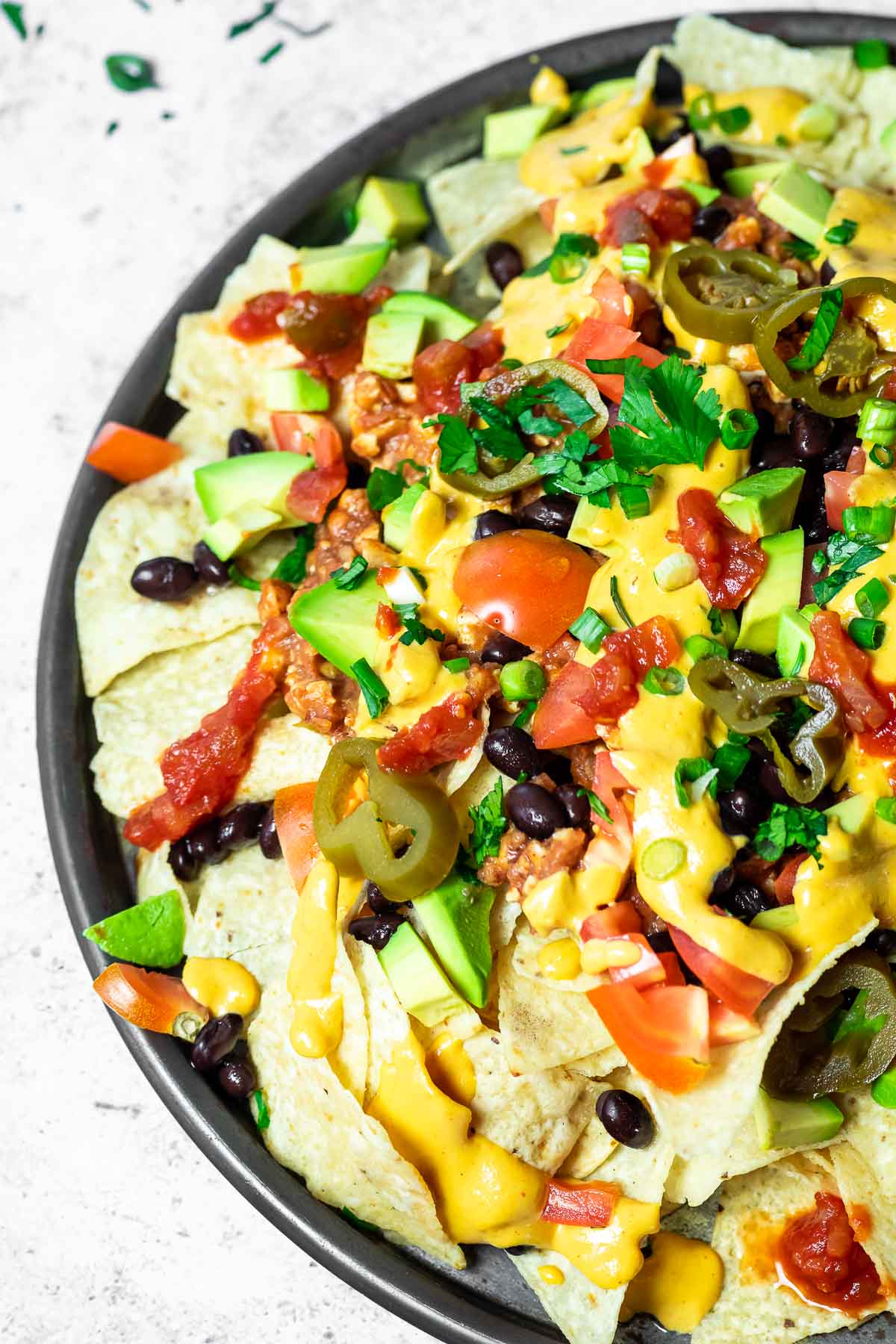 Bird view on a platter with loaded nachos.