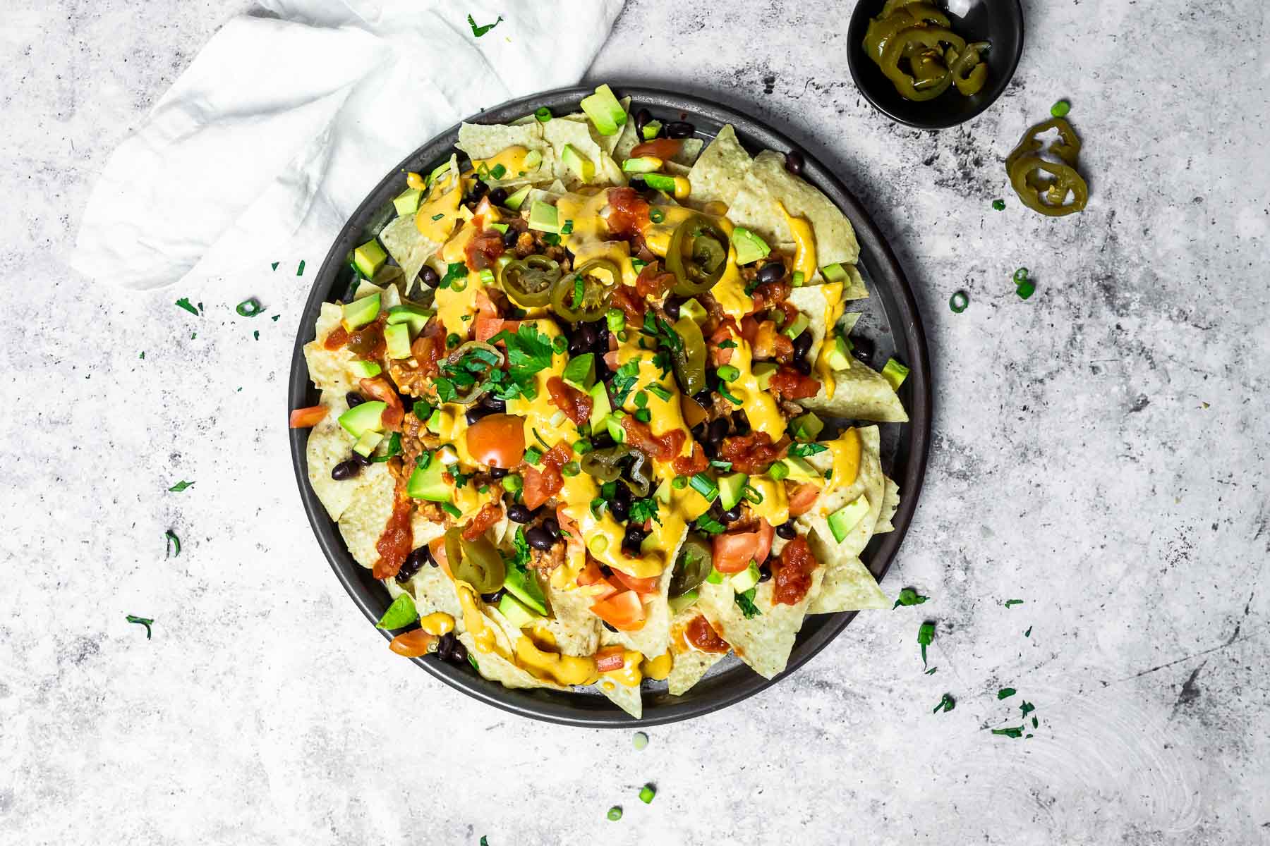 Bird view on a whole platter with vegan loaded nachos