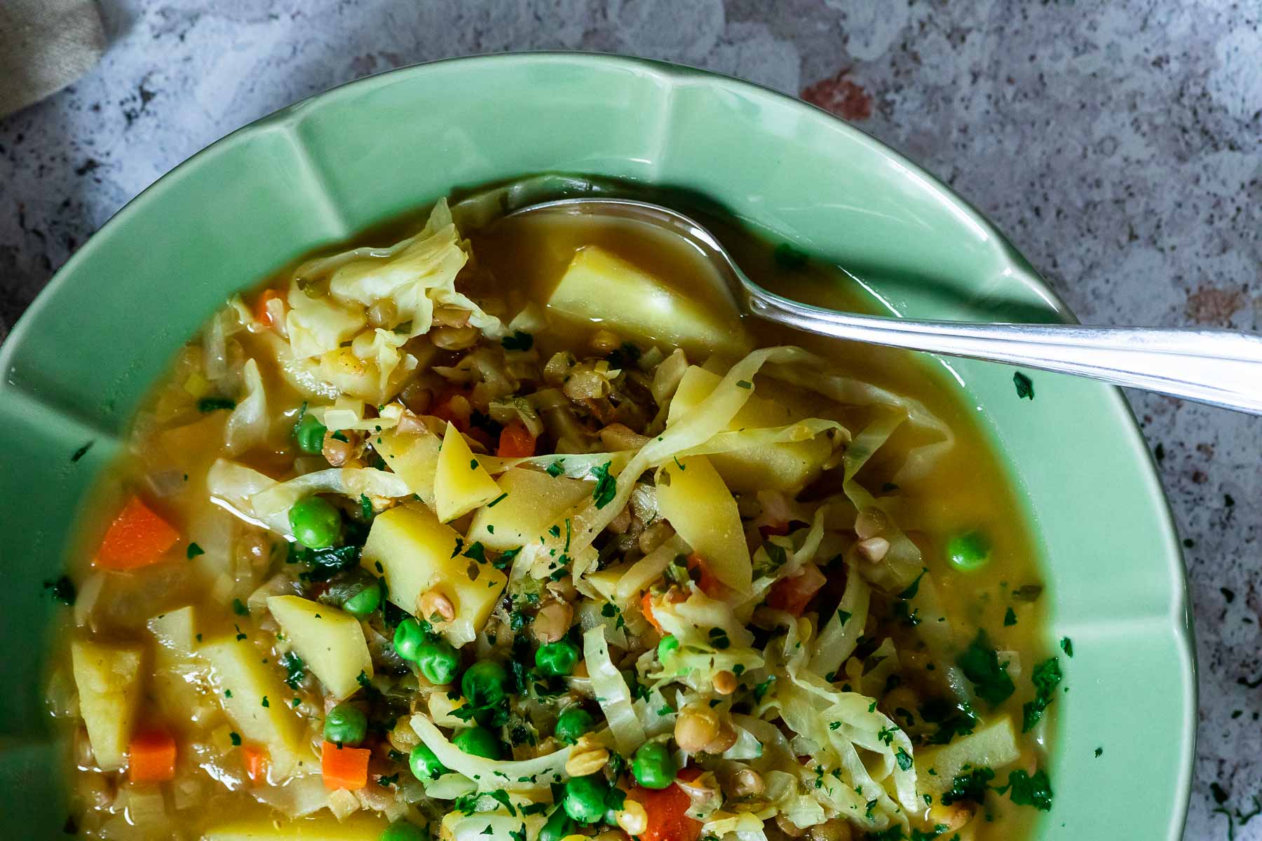 Close up of a bowl with cabbage lentil stew.