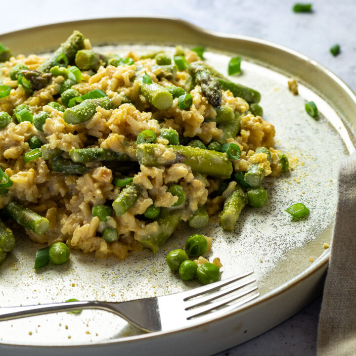 Close up of vegan pea and asparagus risotto on a plate