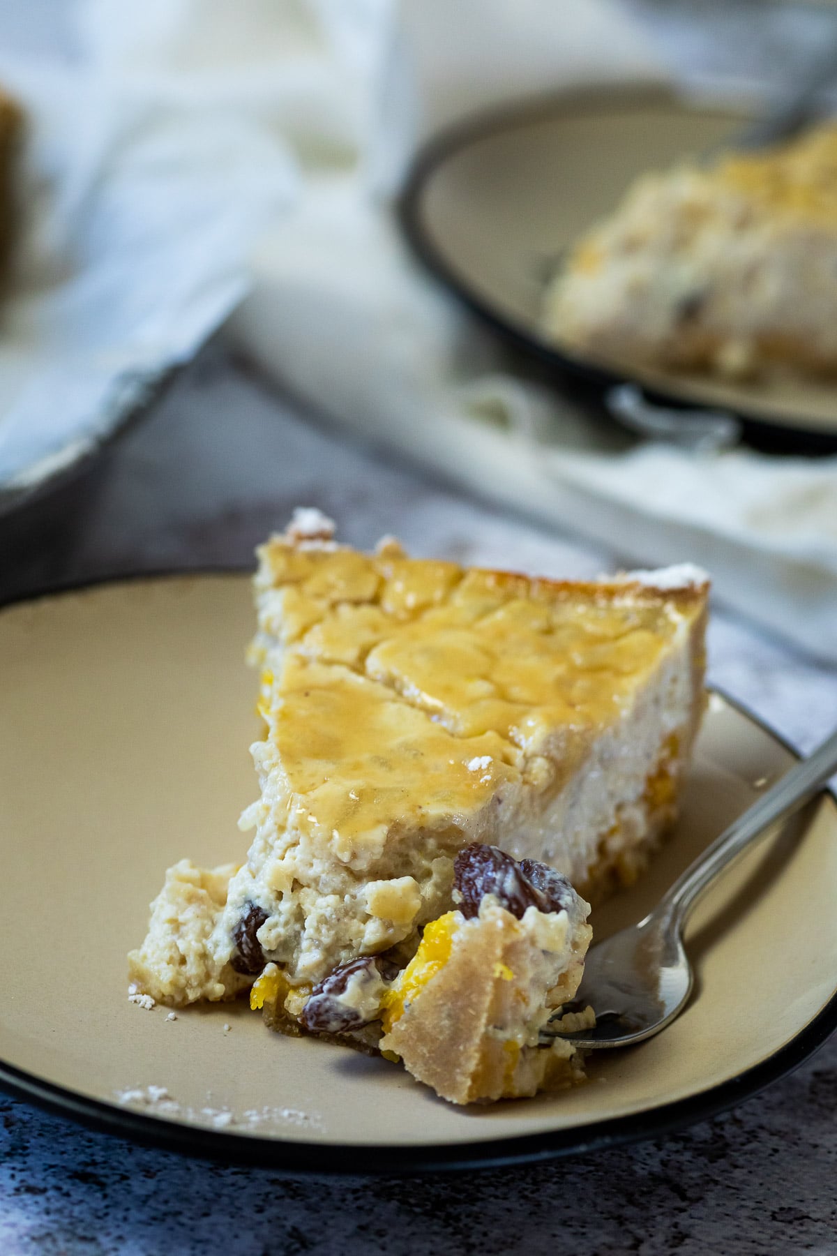 close up of a vegan rice pudding pie piece on a plate with a fork