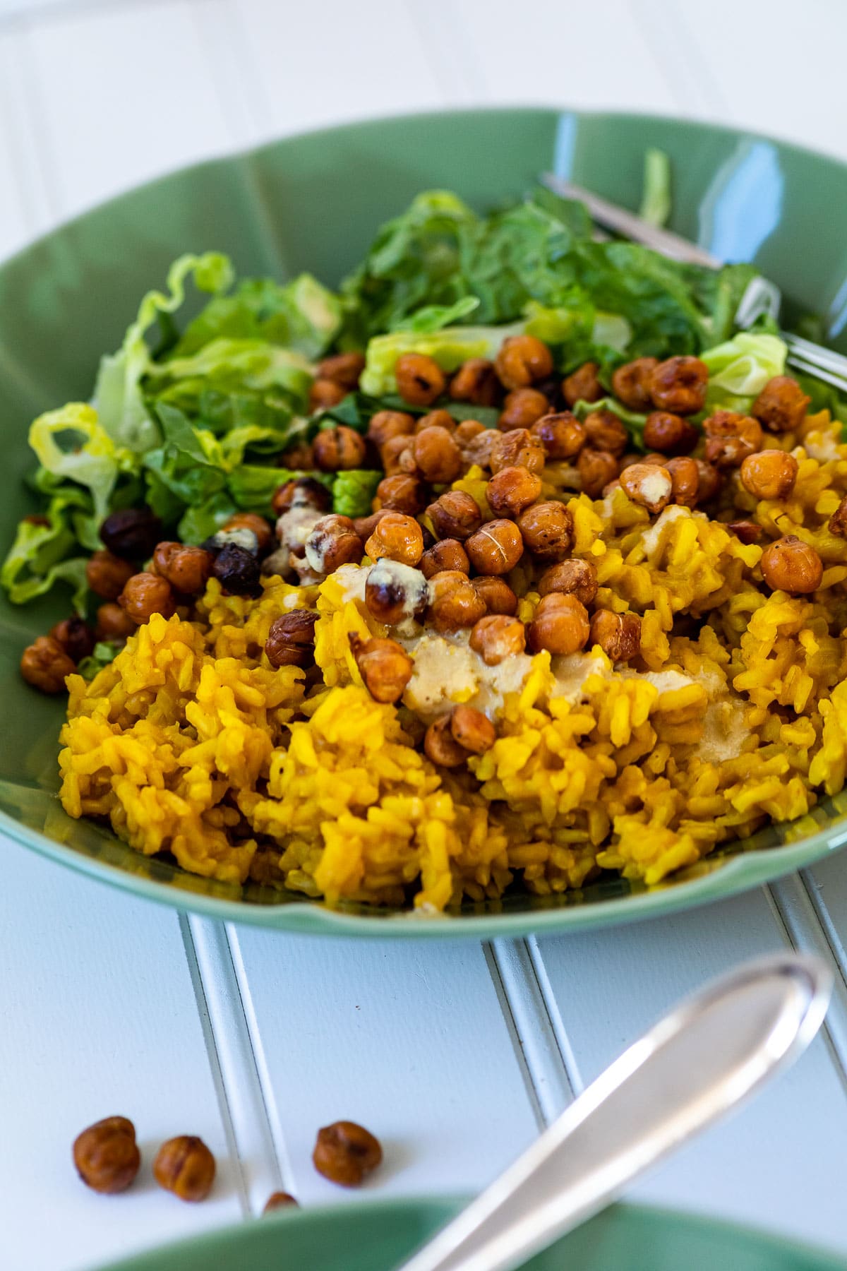 One turmeric rice bowl in the back of another bowl.