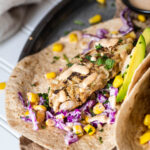 One vegan fish stick in focus served in a vegan taco.