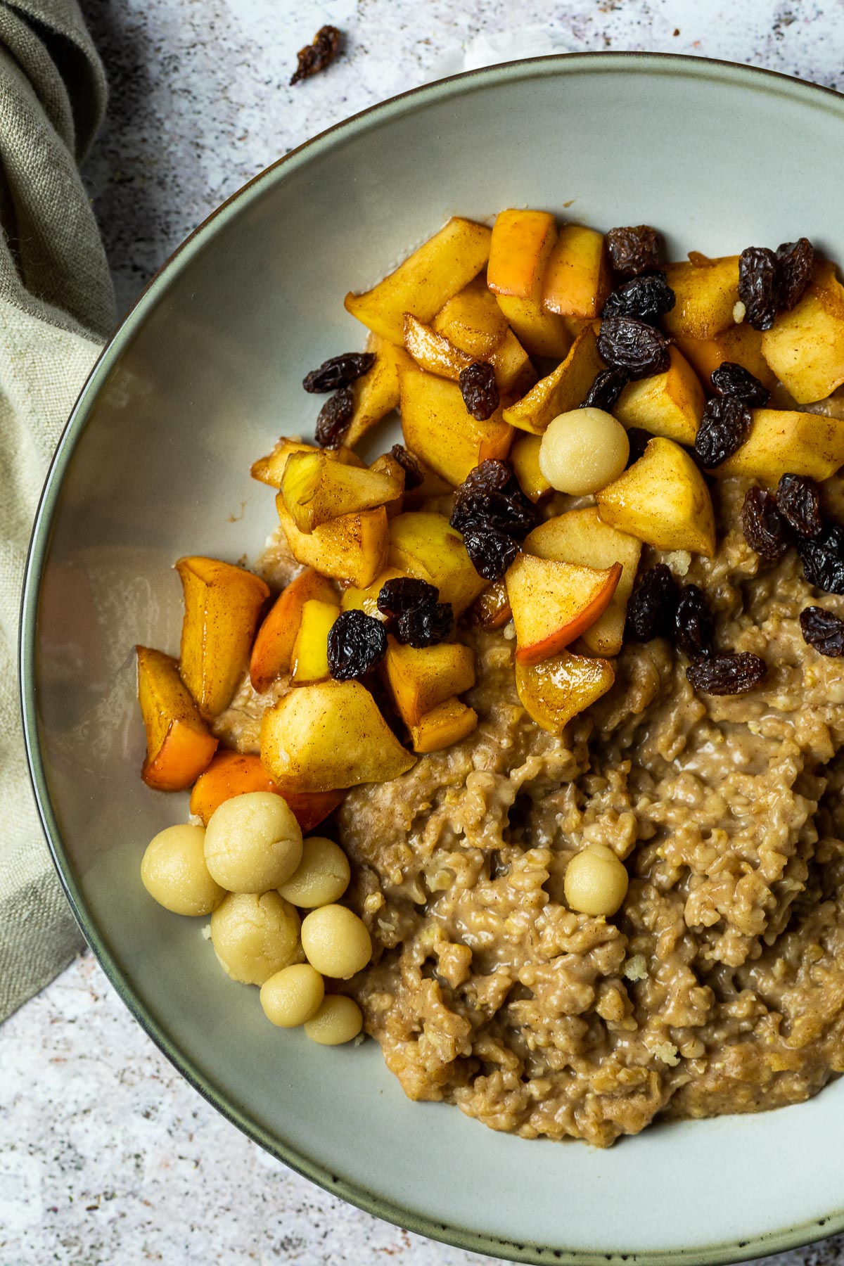 Close up of one plate with oatmeal and baked apples and marzipan