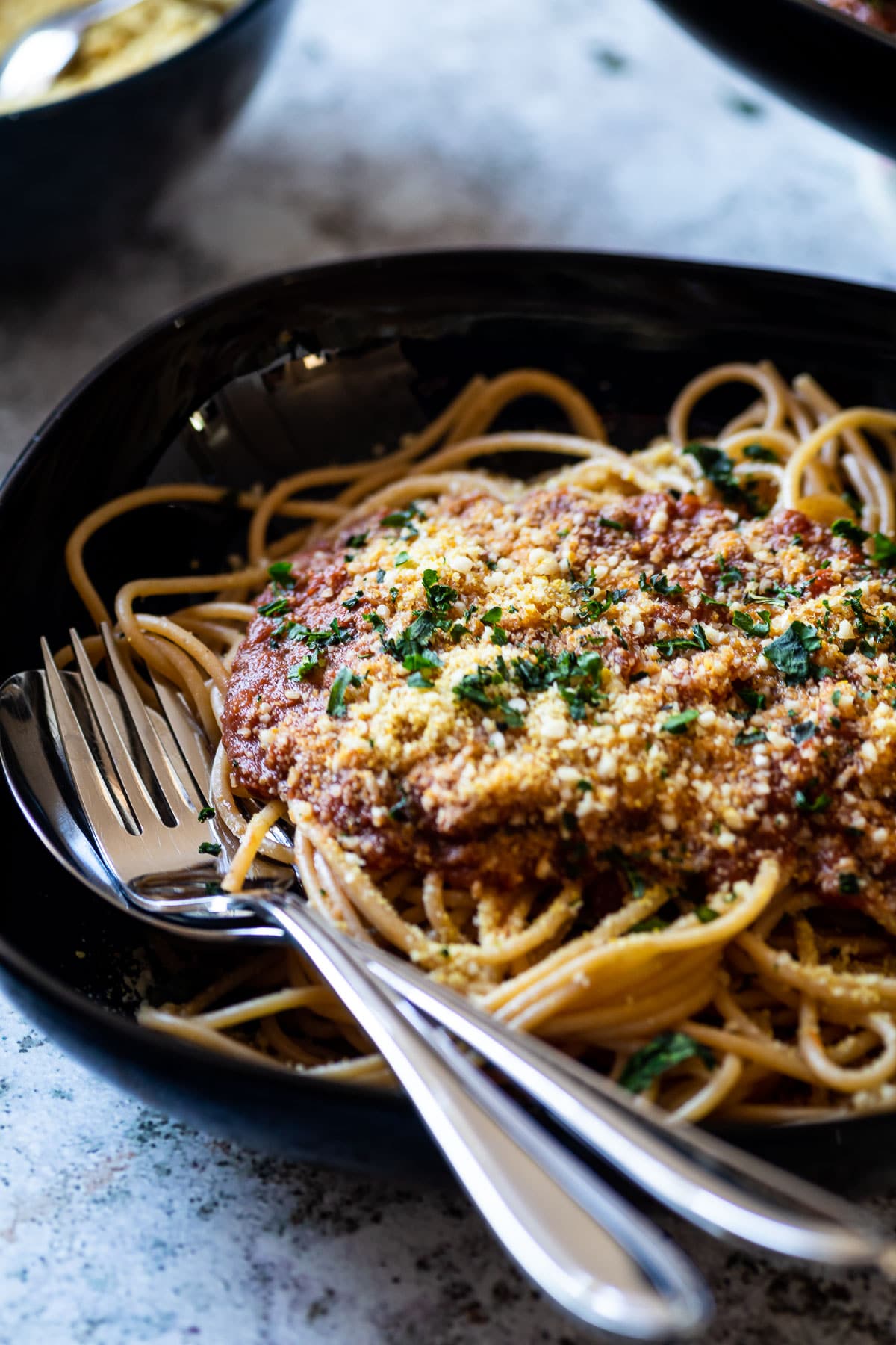 Spaghetti topped with vegan bolognese Sauce and vegan Parmesan