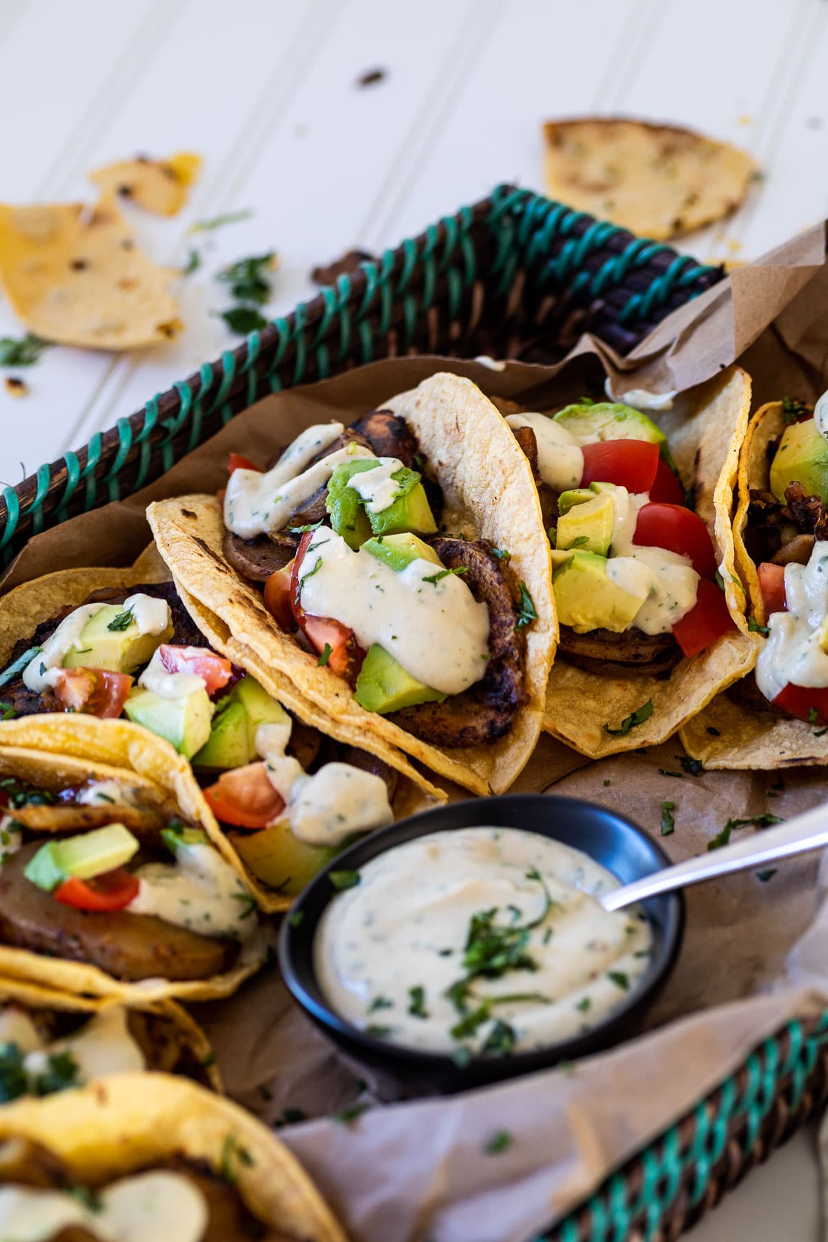 Potato tacos and garlic sauce bowls served on a tray