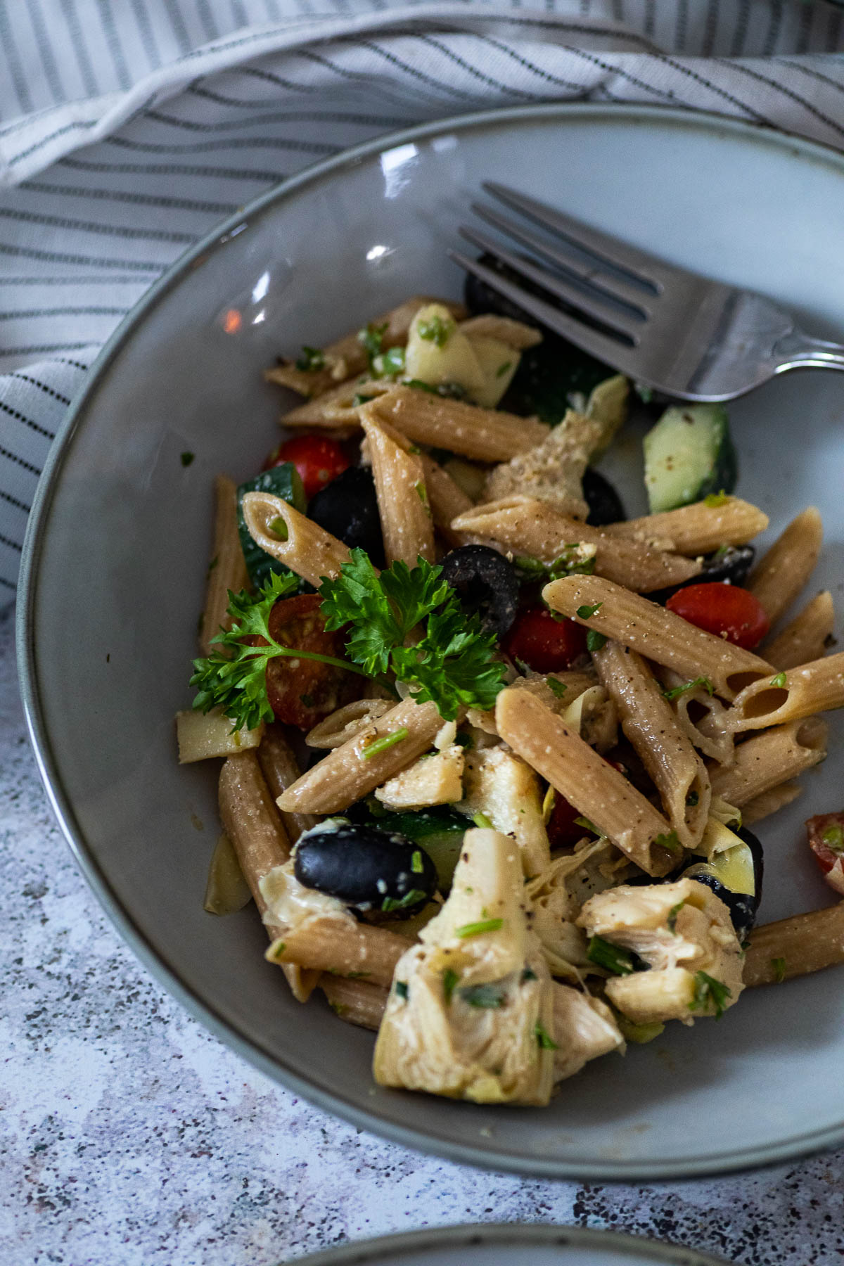 A plate with vegan artichoke pasta salad