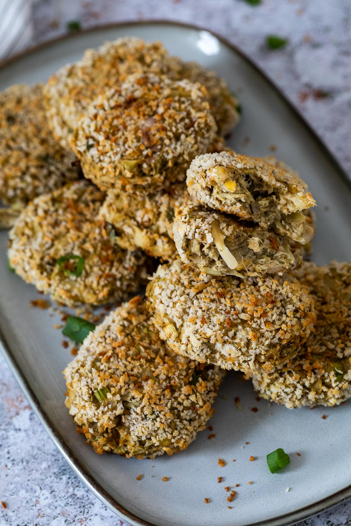 No Crab Cakes on a plate with one crab cake halfed to show the texture and inside