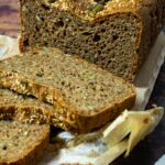 Spelt Bread topped with sesame seeds and pepita seeds cutted side in focus and some slices blurred in front