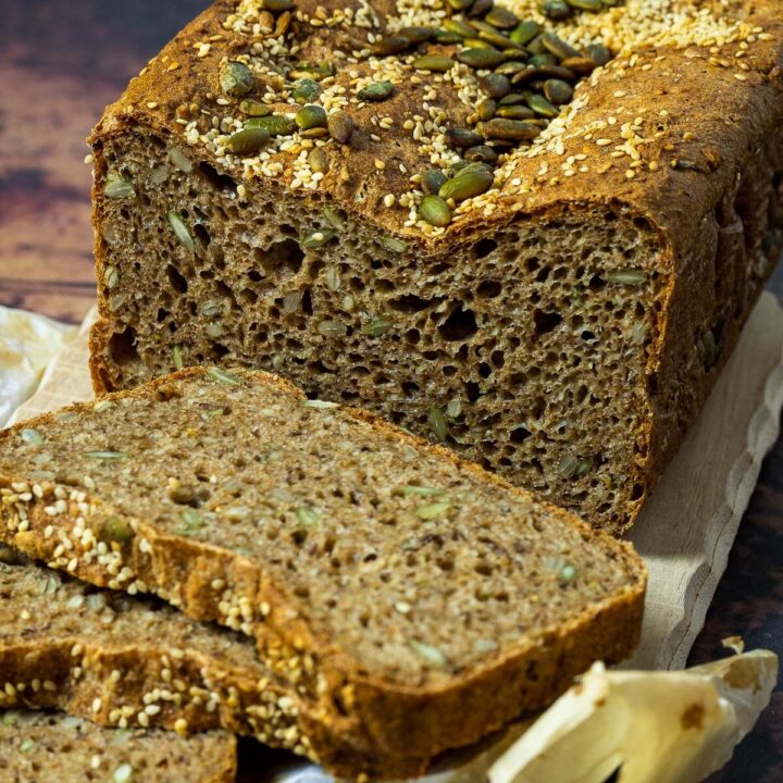 Spelt Bread topped with sesame seeds and pepita seeds cutted side in focus and some slices blurred in front