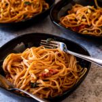 3 bowls with tomato alfredo spaghetti with sun dried tomatoes and spinach