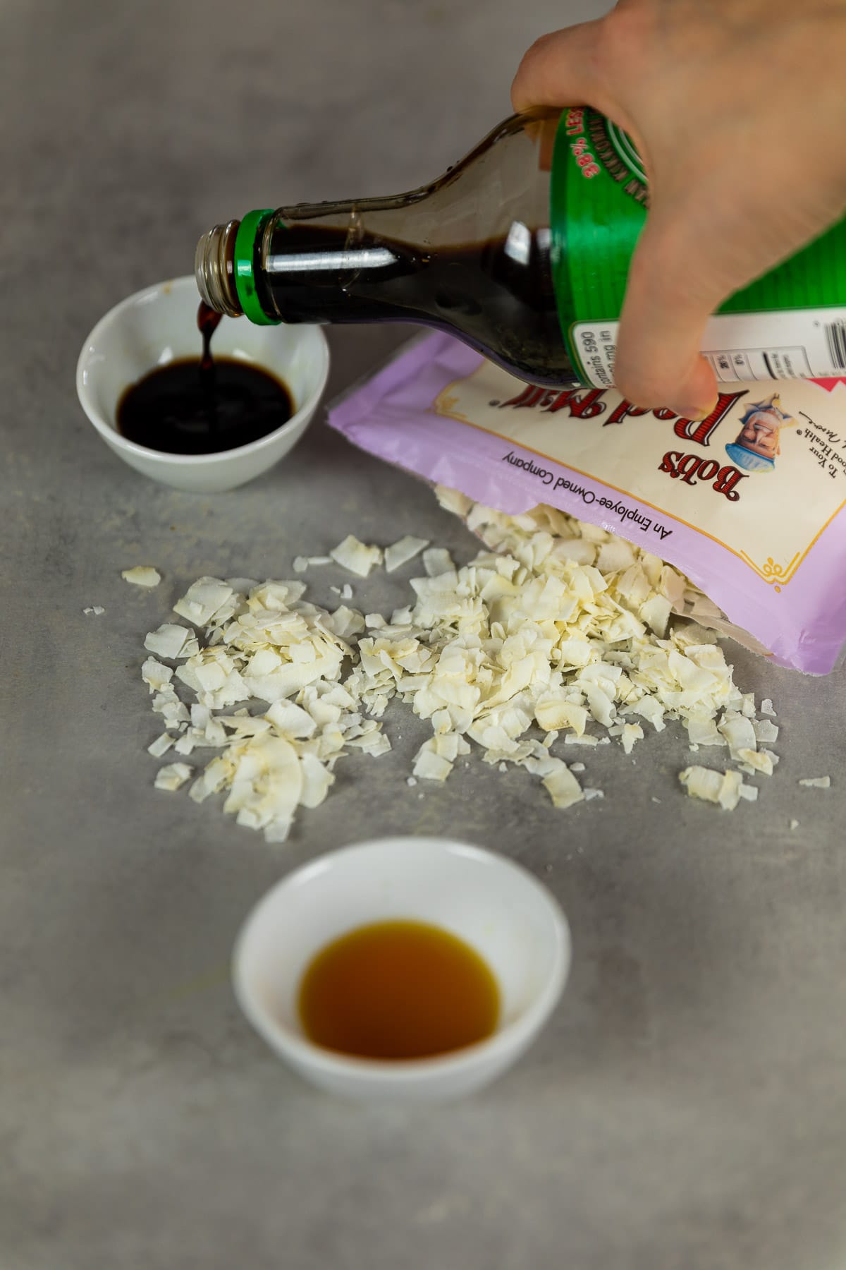 Ingredient shot for the coconut bacon with soy sauce, coconut flakes and liquid smoke