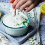 Dipping a carrot in vegan ranch dip